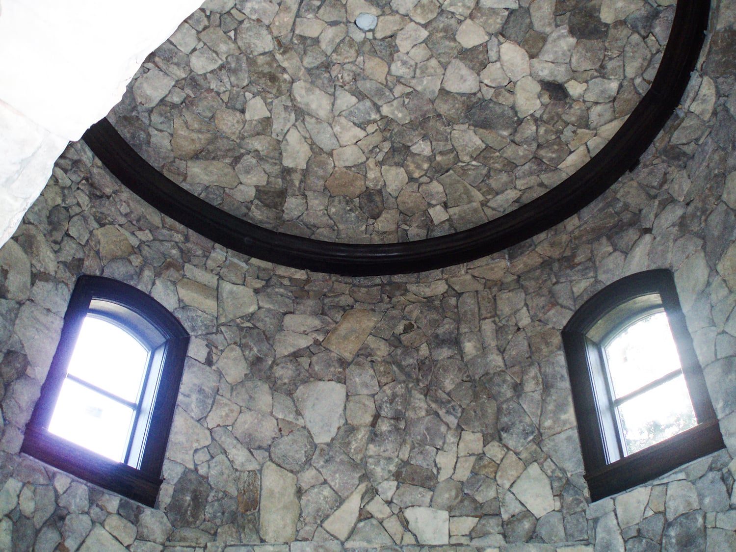 Front entry addition with natural stone columns and custom covered porch