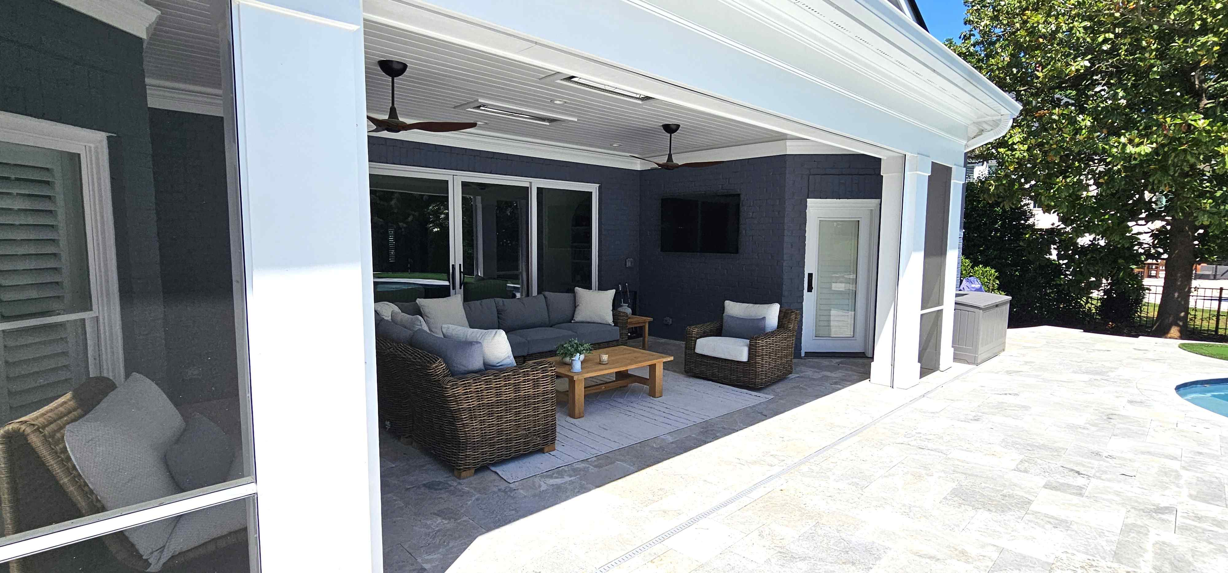 Screened porch with premium metal roof and power screens overlooking the new pool